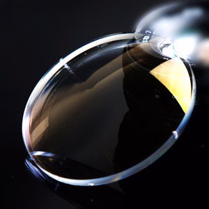 Photochromic bifocal lenses for indoor and outdoor vision programs